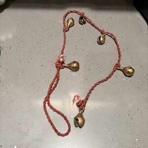 Vintage etched brass bells on rope